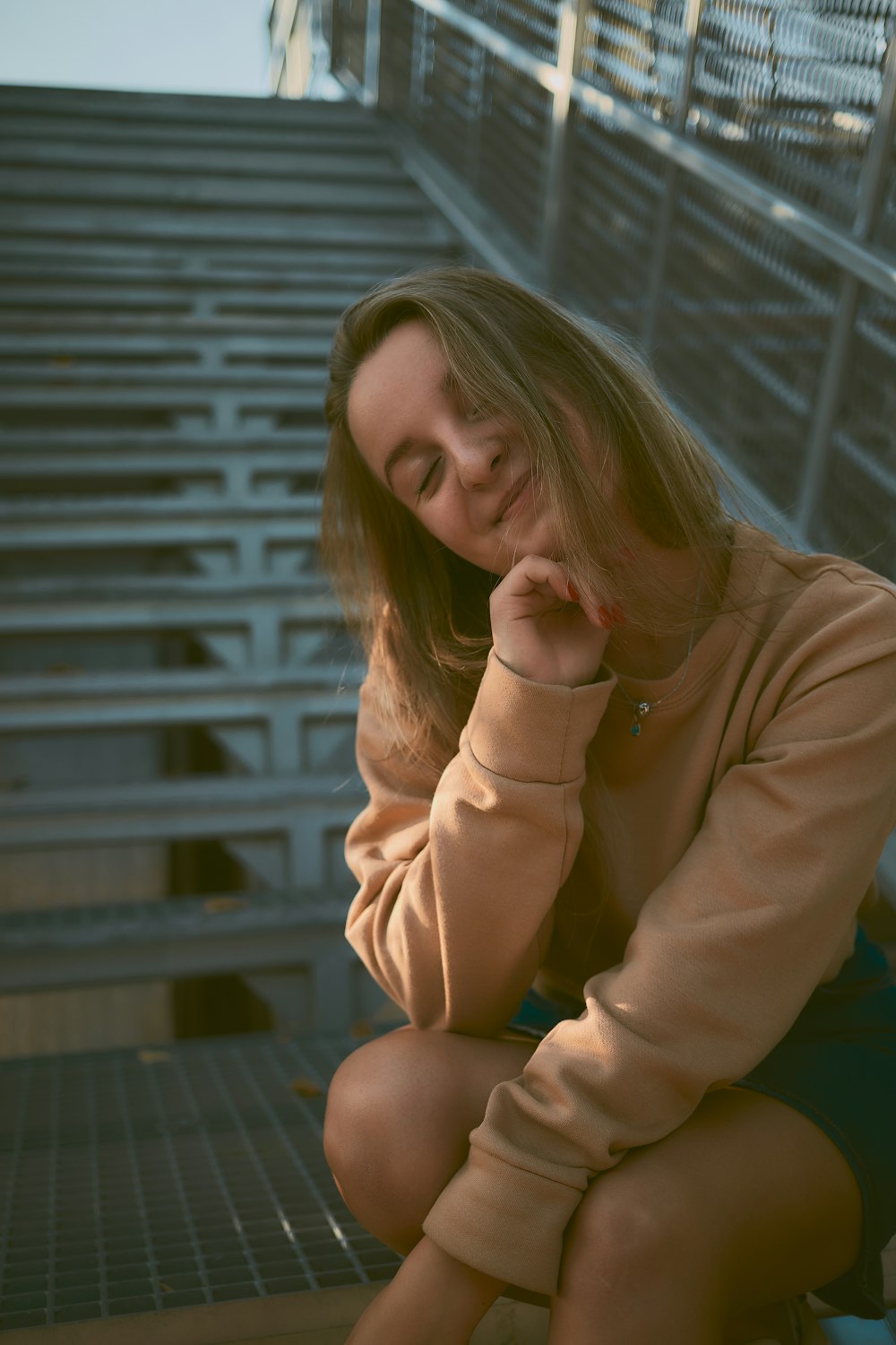 woman in brown long sleeve shirt sitting on brown wooden bench