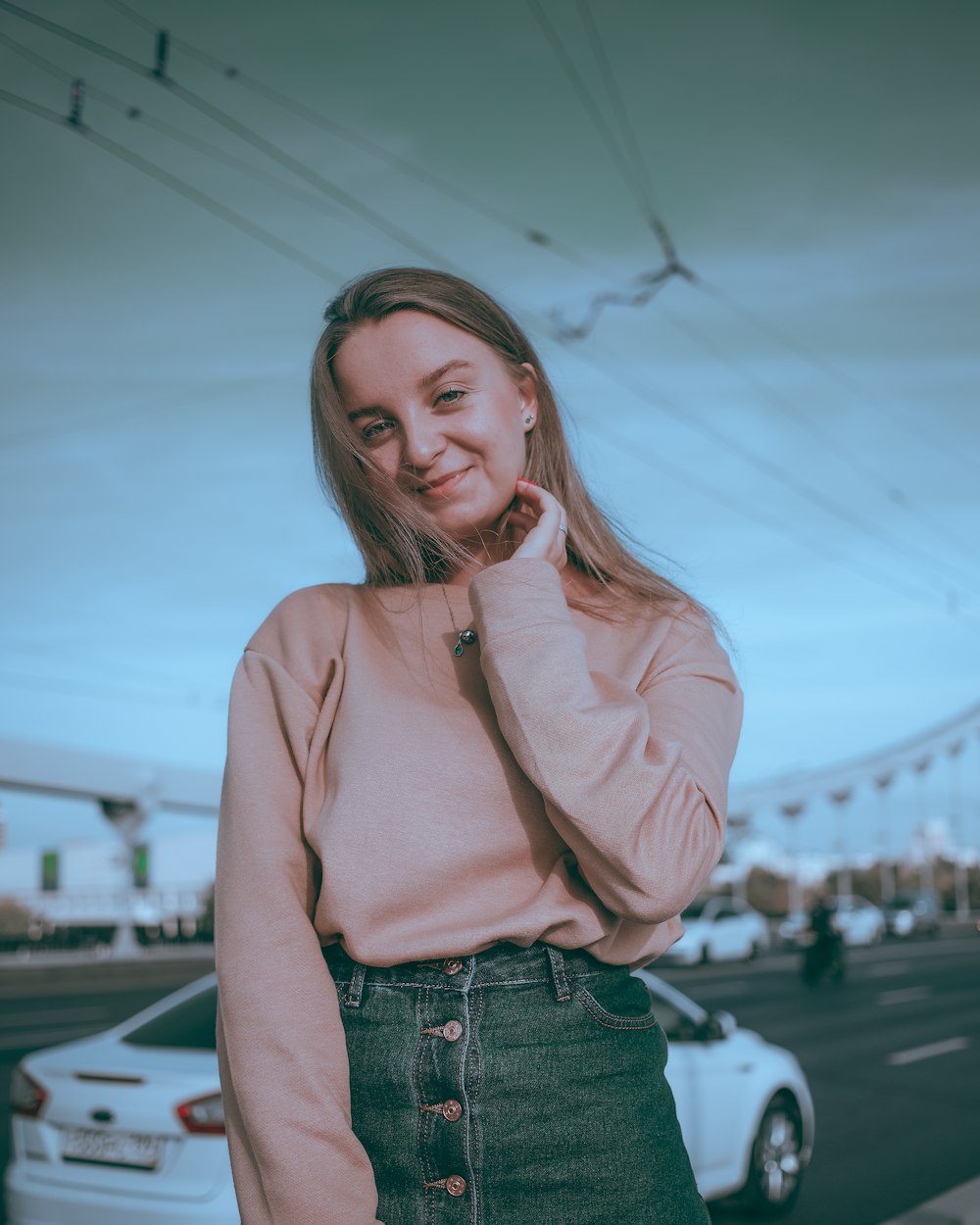 woman in pink zip up jacket and blue denim jeans smiling