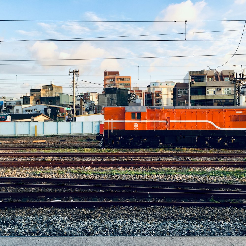 red and black train on rail tracks during daytime