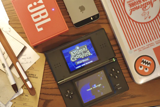 black nintendo game boy on brown wooden table