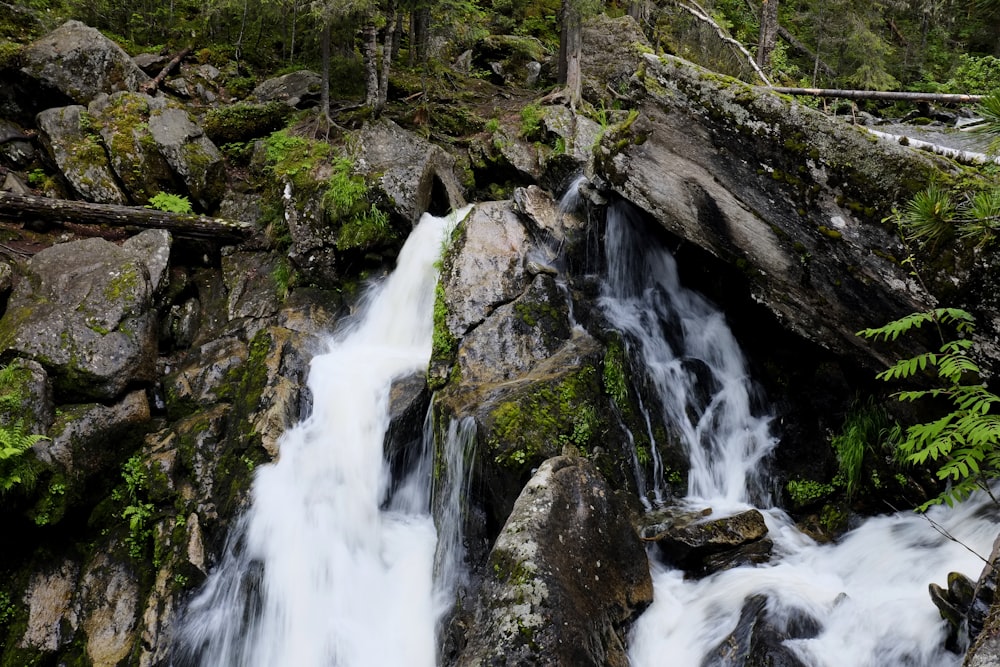 water falls on brown rocky mountain