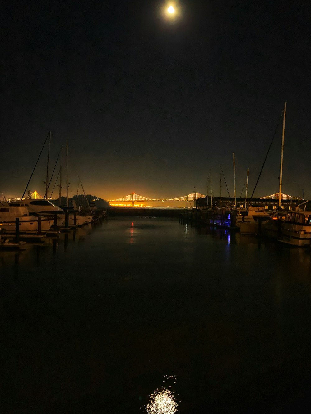 weißes und braunes Boot am Dock während der Nacht