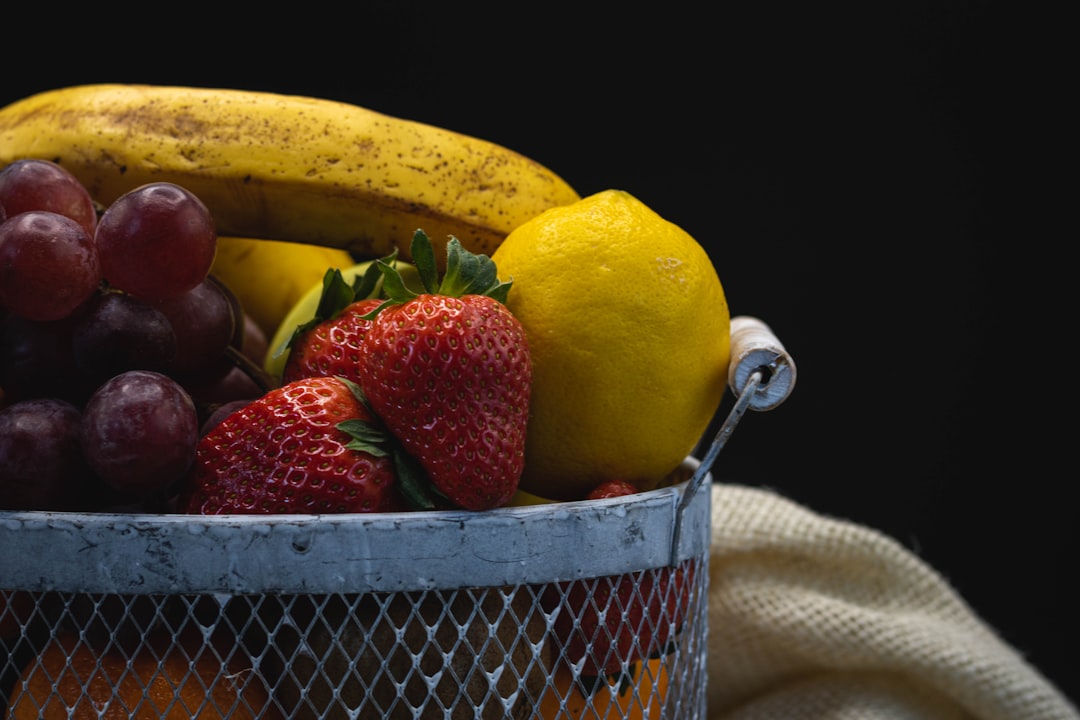 red strawberries on stainless steel basket