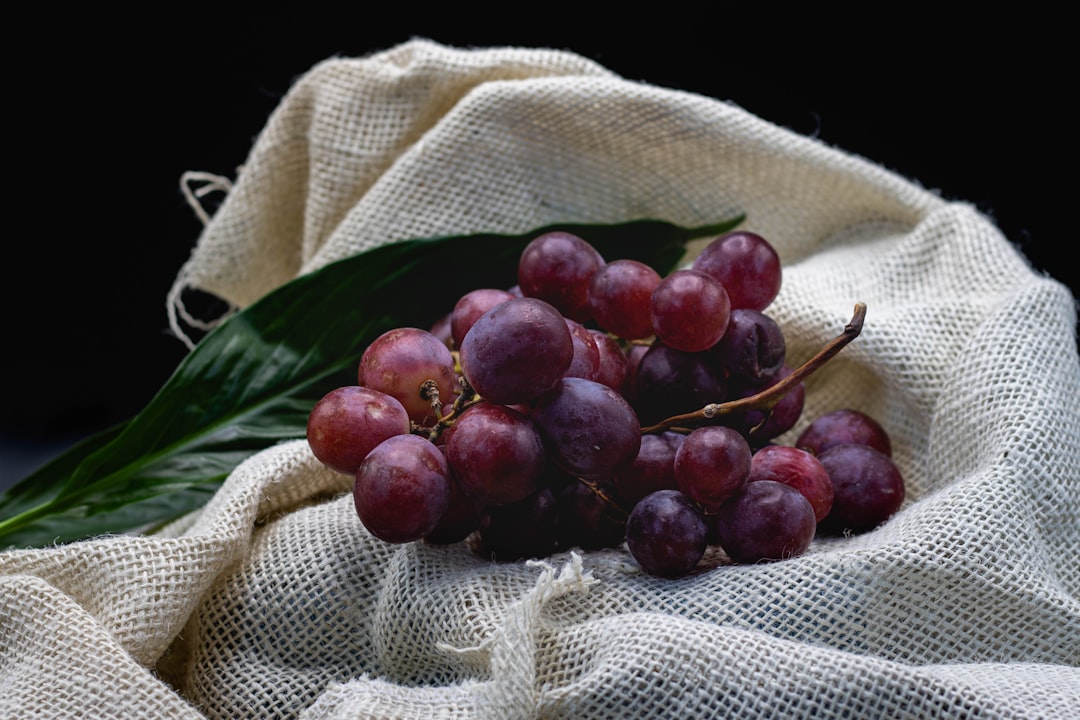 red round fruits on white textile