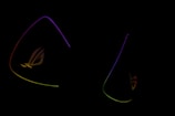 Dark background is highlighted by glowing outlines of colorful triangular shapes with the letters 'ROG' subtly visible, suggesting a gaming or tech-related theme.