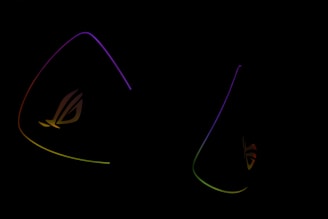 Dark background is highlighted by glowing outlines of colorful triangular shapes with the letters 'ROG' subtly visible, suggesting a gaming or tech-related theme.