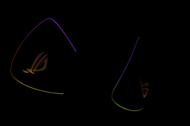 Dark background is highlighted by glowing outlines of colorful triangular shapes with the letters 'ROG' subtly visible, suggesting a gaming or tech-related theme.