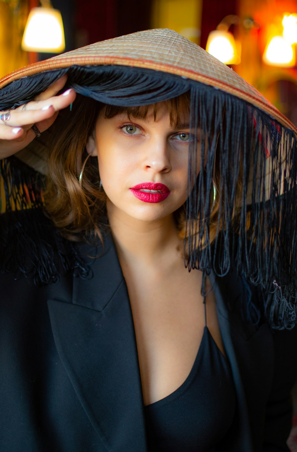 woman in black blazer and red lipstick