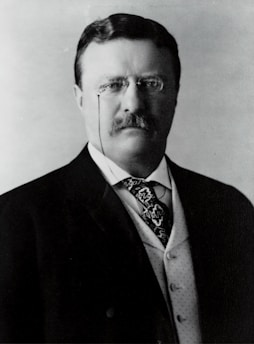 Portrait of Dr. Victor Meira in a modern office setting, wearing a suit and glasses.