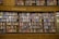 A large wooden bookshelf filled with an extensive collection of books organized into sections labeled as 'Science Fiction' and 'Crime'. The shelves are packed with colorful book spines, featuring diverse titles and authors.