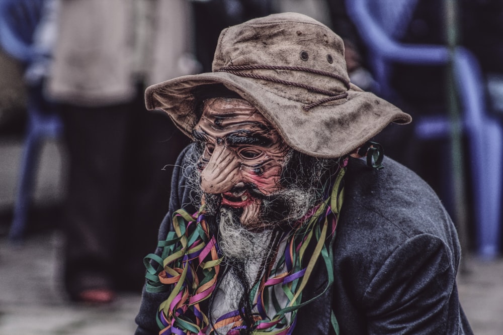 person in black jacket wearing brown hat