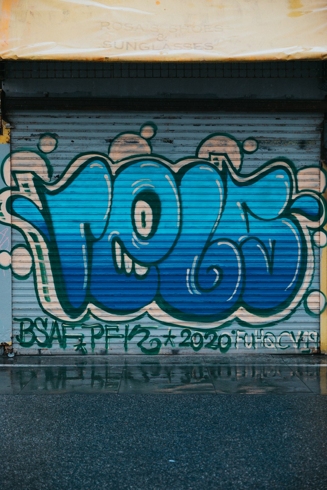 blue and white graffiti on wall