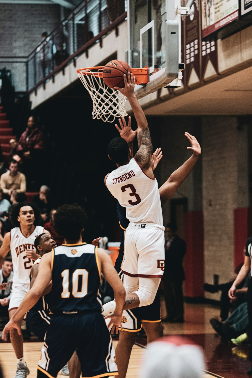 man in white and black basketball jersey shirt playing basketball