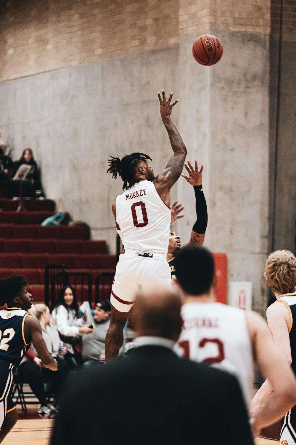 man in white and red jersey shirt raising his hands