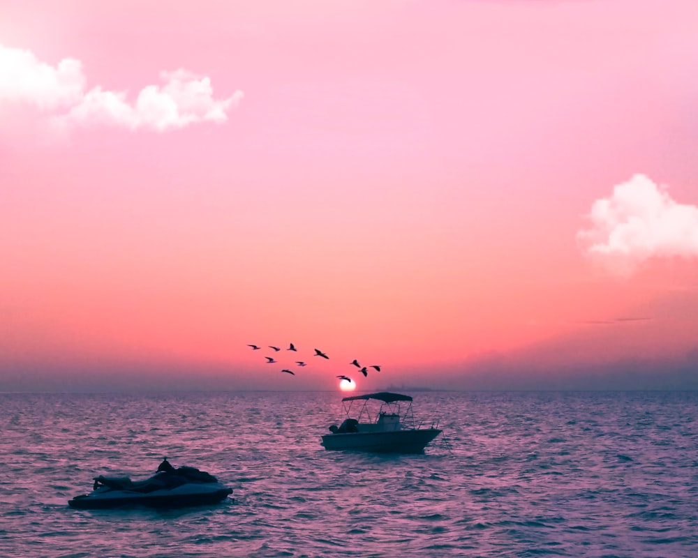 white boat on sea under blue sky during daytime