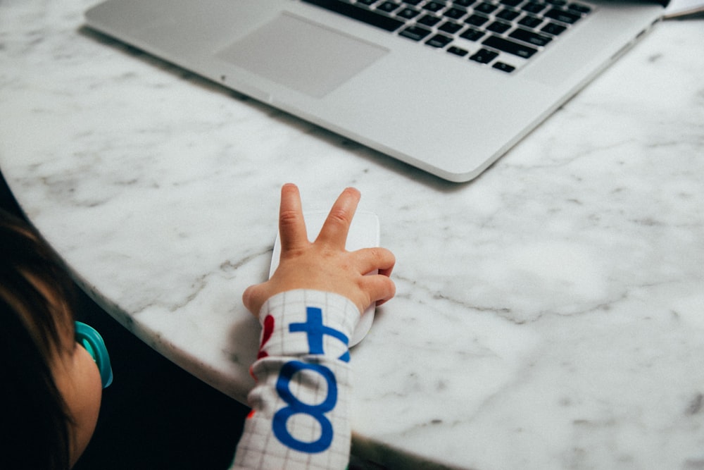 person holding white and blue textile