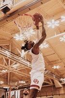 man in white tank top playing basketball