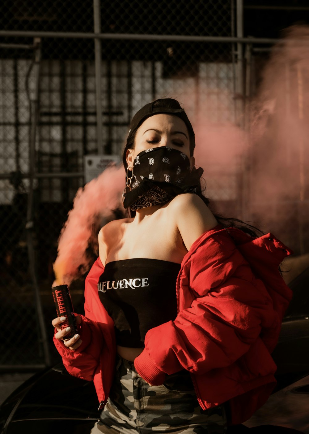 woman in black tank top and red jacket holding microphone