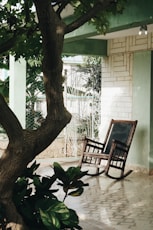 brown wooden rocking chair under green tree