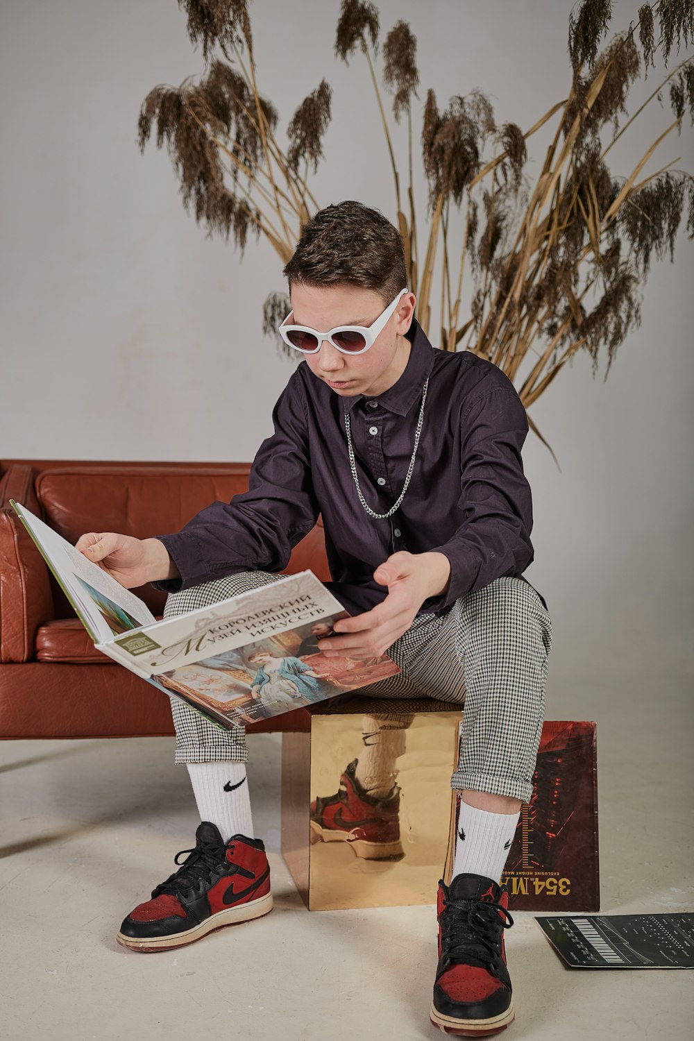 man in black leather jacket reading newspaper