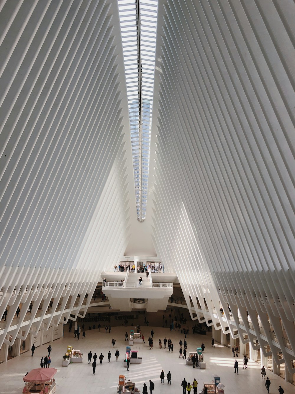 people walking on white concrete building