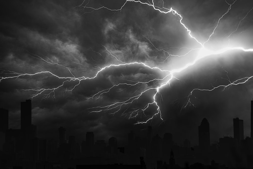 grayscale photo of city buildings under cloudy sky