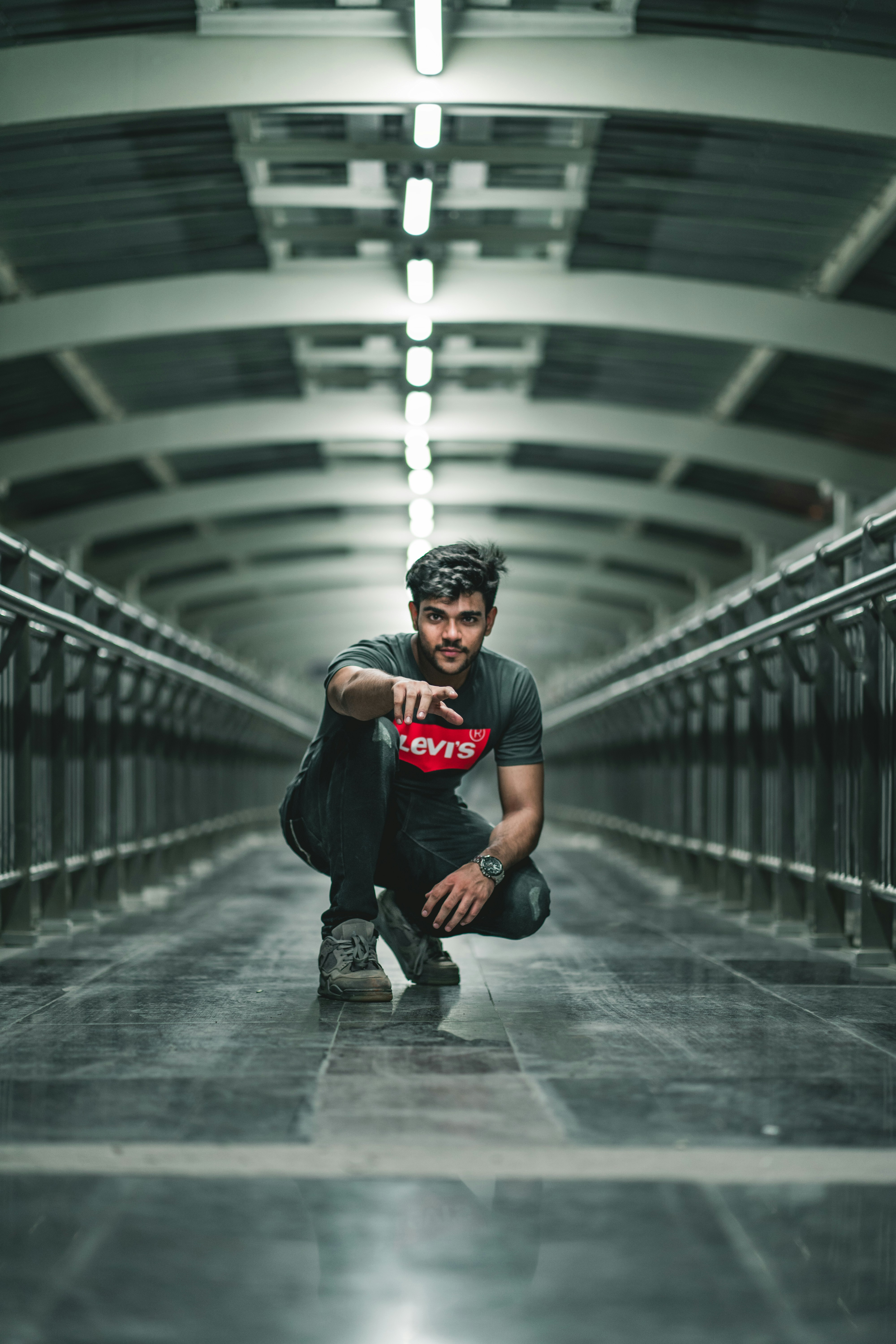 man in black crew neck t-shirt and black pants wearing black cap