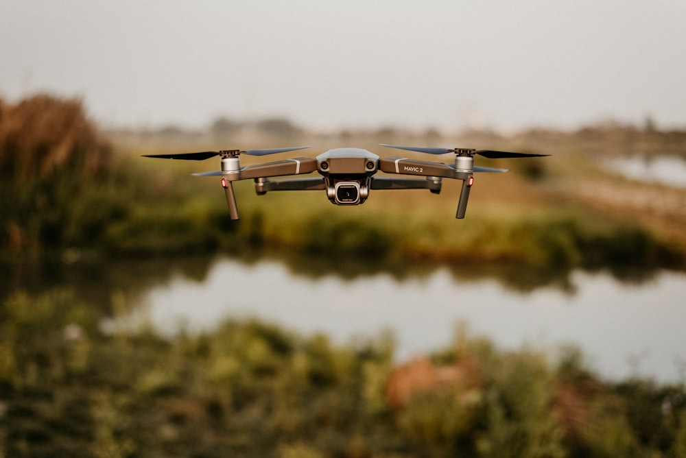 white and brown drone flying in mid air during daytime