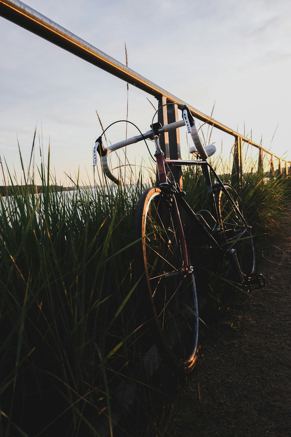 black bicycle on green grass field during daytime