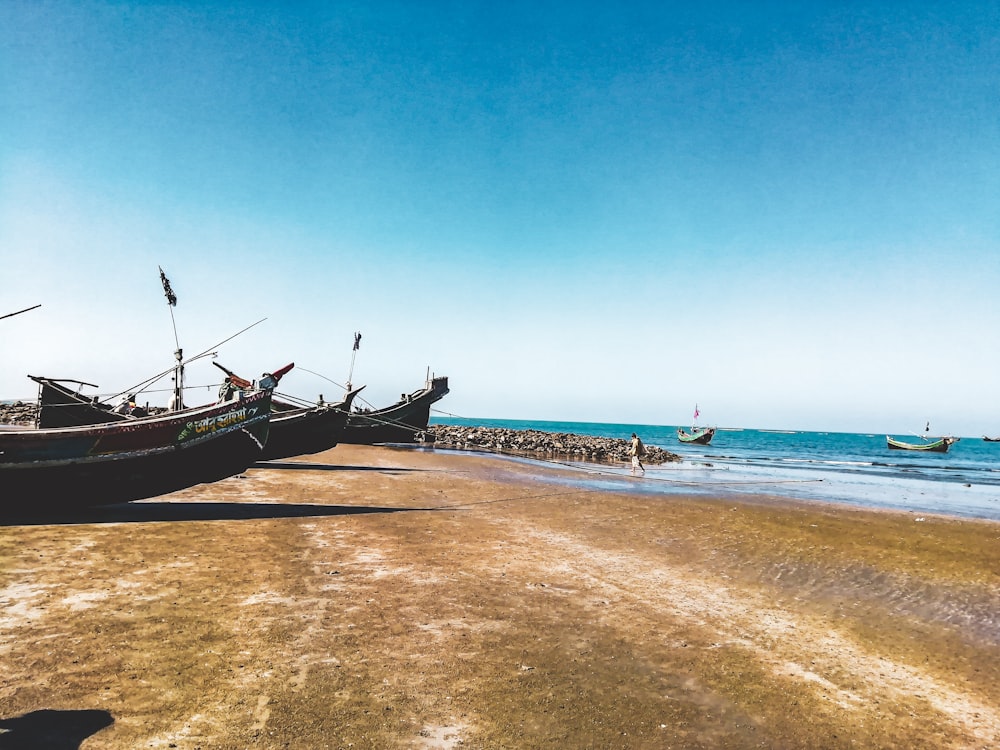 brown boat on sea shore during daytime