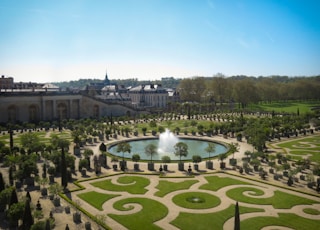 green grass field with fountain during daytime