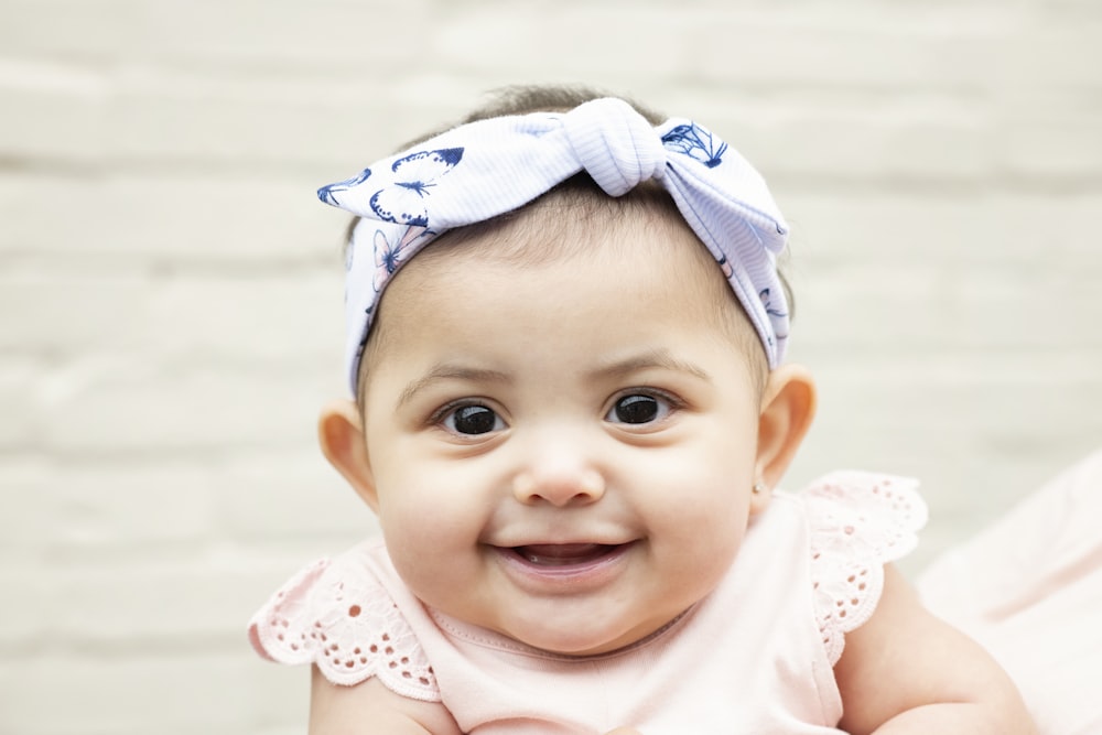 baby in white and pink polka dot tank top