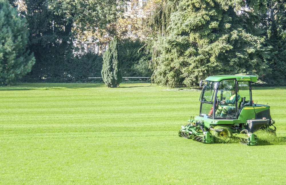 green and black utility truck on green grass field