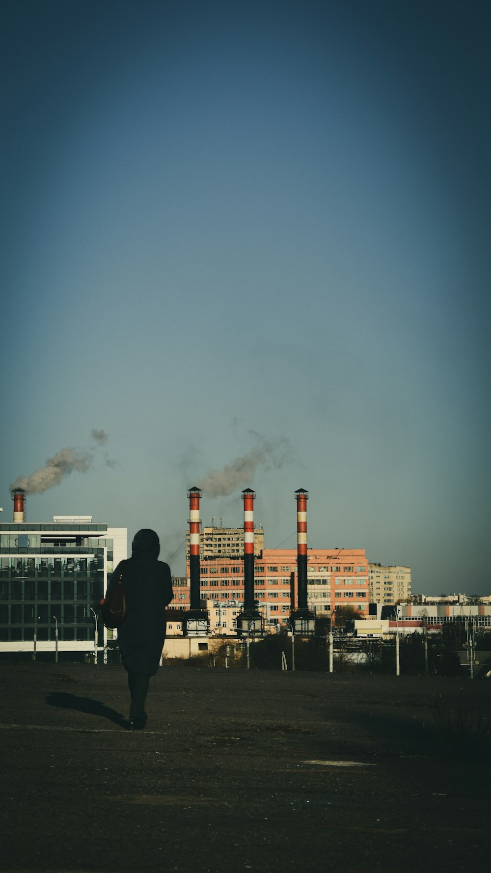 man in black jacket standing on building roof top during night time