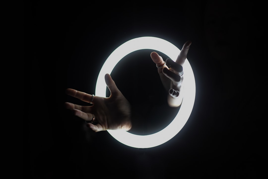persons hand on white round light