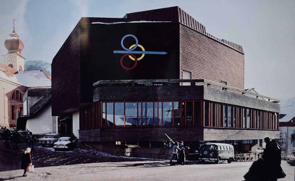 people sitting on bench near brown concrete building during daytime