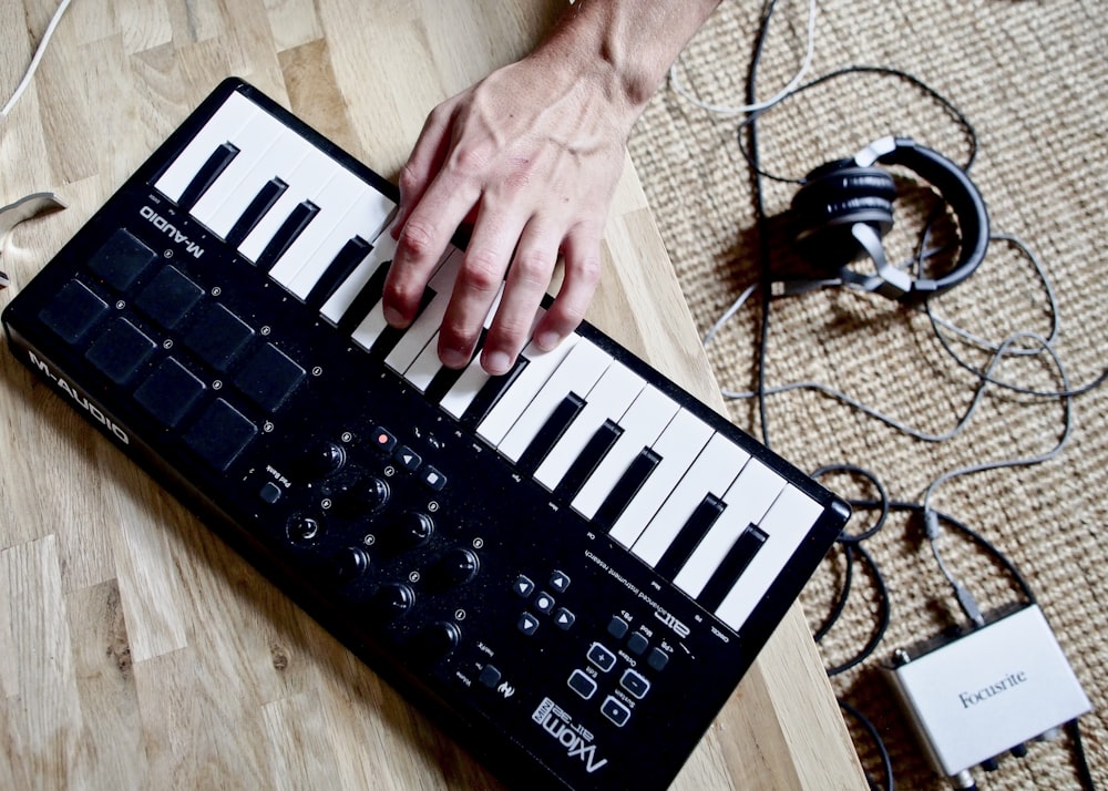 person holding black and white braille keyboard