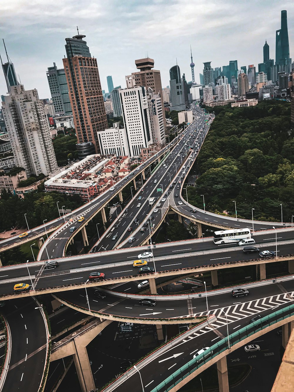 cars on road near city buildings during daytime