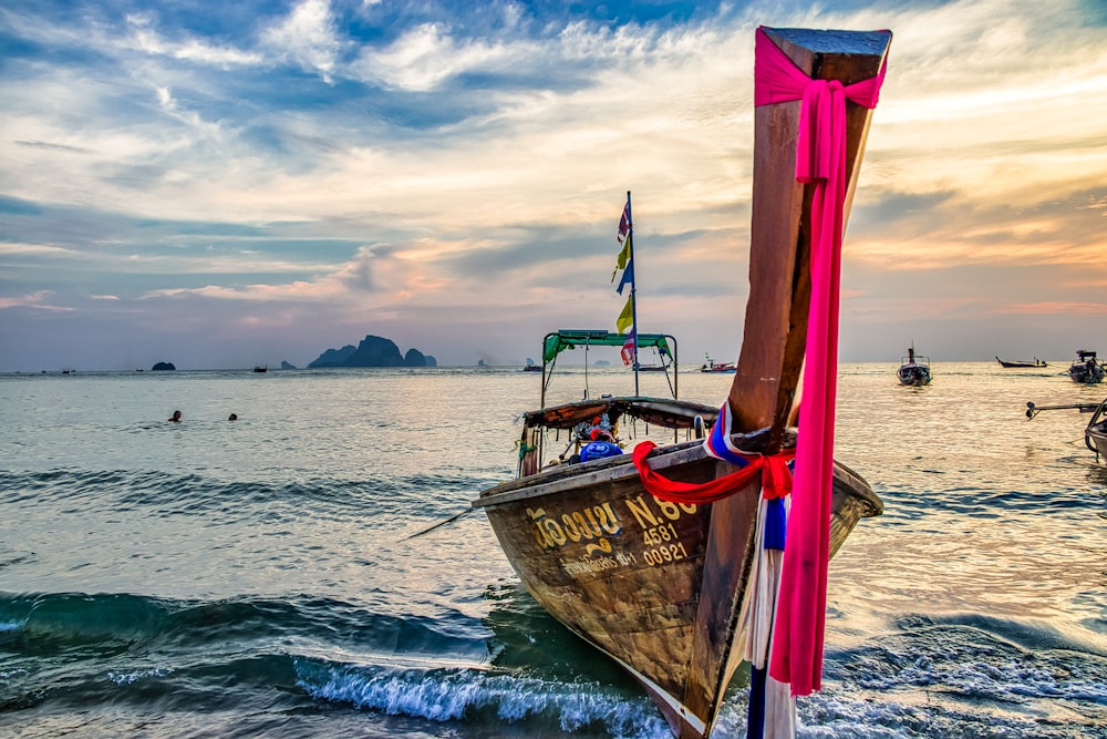 brown boat on sea during daytime