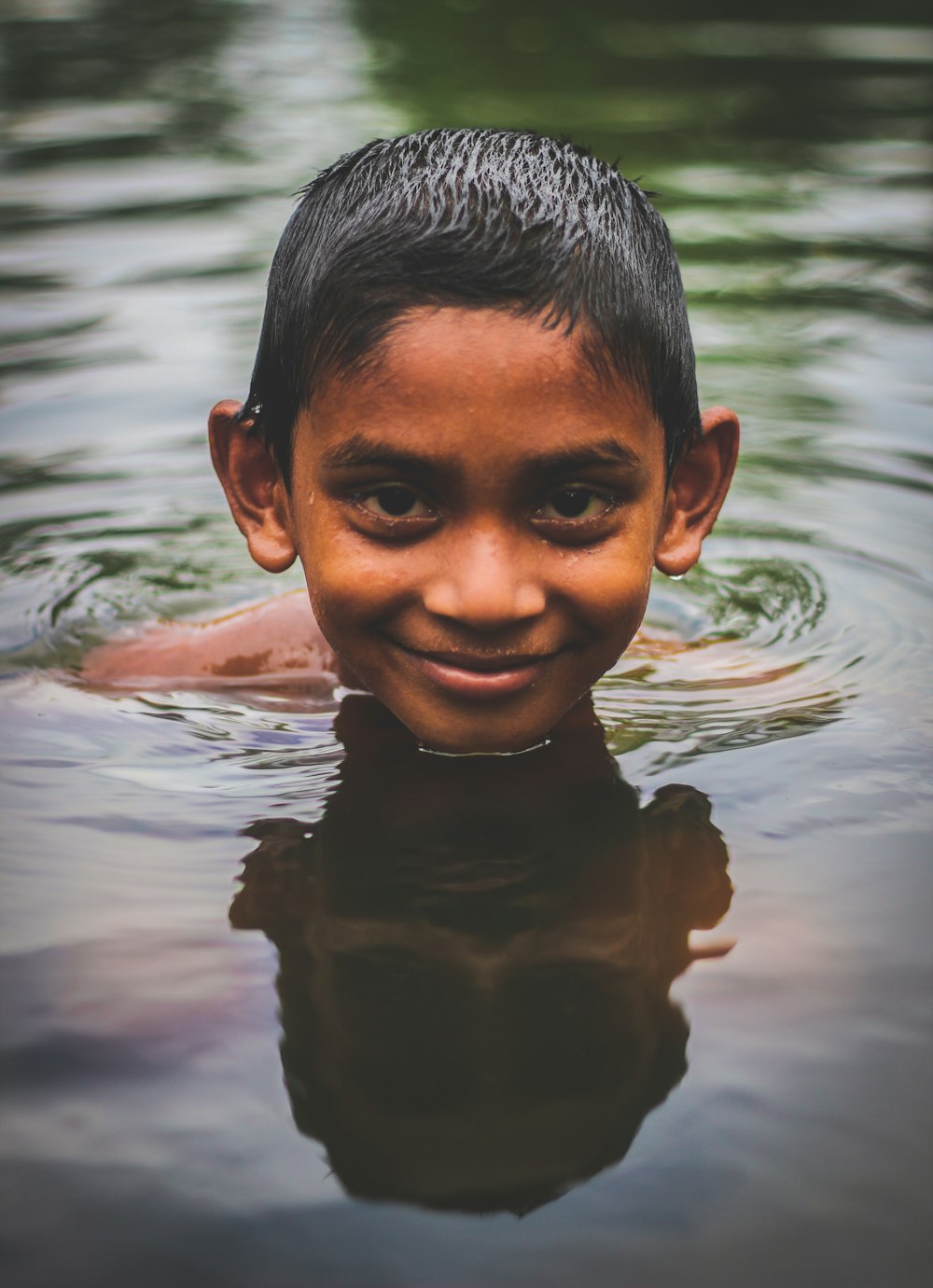 boy in water during daytime