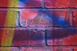 Close-up of colorful graffiti art on a brick surface.