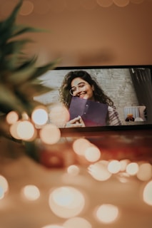 A professional woman smiling while working on a computer