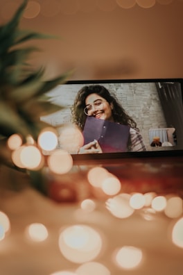 A warm photo of a smiling client reviewing their new landing page on a laptop.