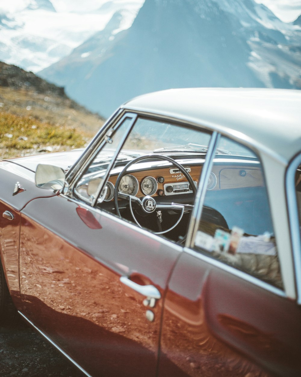 white car on brown dirt road during daytime