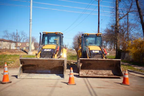 yellow and black heavy equipment on snow covered ground during daytime