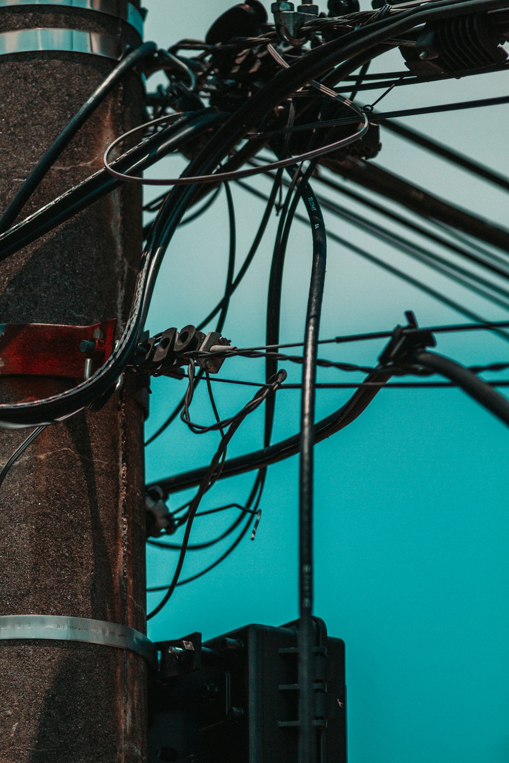 black electric wires on brown wooden post