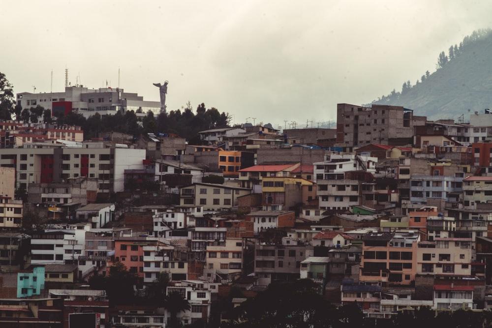 brown and white concrete buildings under white clouds during daytime