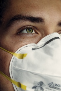person in white face mask
