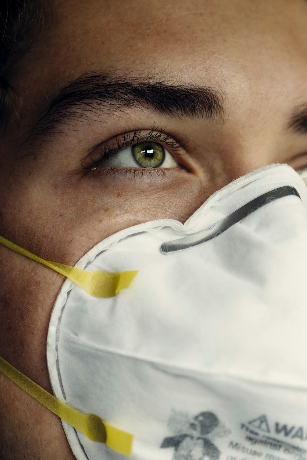 person in white face mask