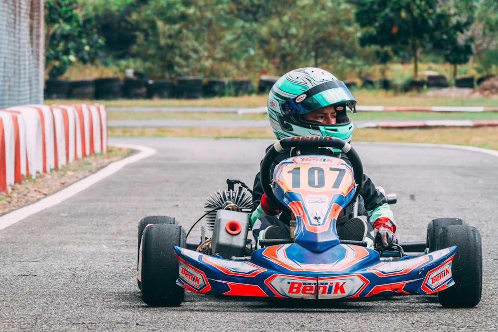 blue and red f 1 race car on track during daytime